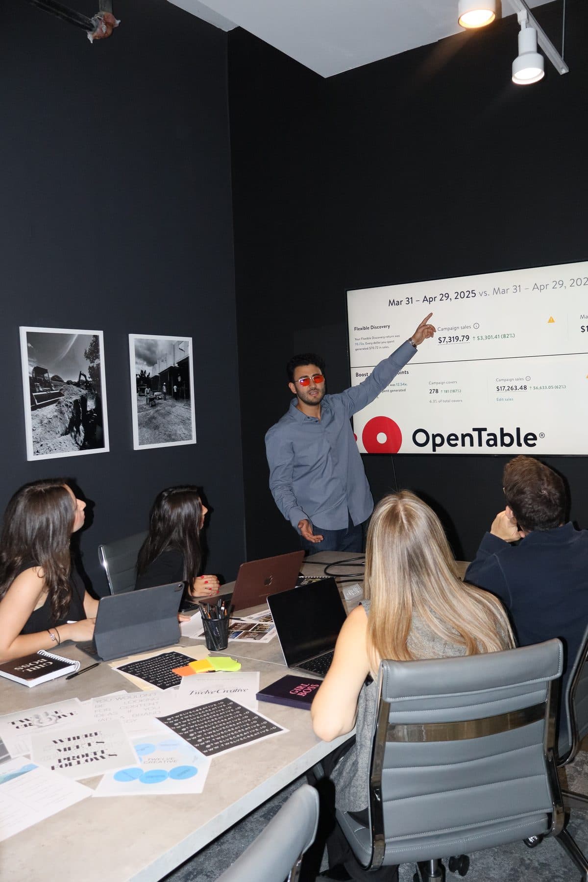 Carlos Doce presenting reservation results to a restaurant team